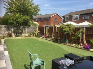 a backyard with a lawn with a table and chairs at Welcome to your stay The Nest in Bolton