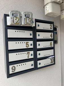 a shelf with numbers and clocks on the wall at Sarah Relax 1 in Drobeta-Turnu Severin