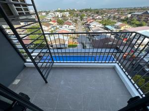 a balcony with a view of a swimming pool at Wanderlust Homes @ Armadale Residence in Kuching