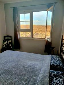 a bedroom with a bed and a window with a view at 'Casa Ideal' A22 - Las Arenas Complex in Caleta De Fuste