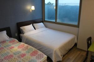 Voodi või voodid majutusasutuse Bexco Hostel B&B toas
