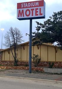 a sign for a station motel in front of a building at Stadium Motel - Lubbock Medical Center in Lubbock