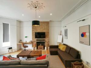 a living room with a couch and a table at Church Retreat - A Magnificent Sea Side Apartment in Hastings