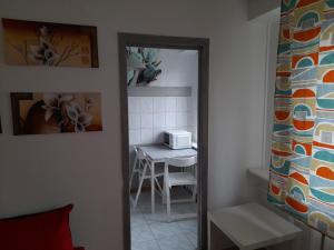 eine Küche mit einem Tisch und einer Mikrowelle im Zimmer in der Unterkunft APARTAMENT LOTNIKÓW 7 in Płock
