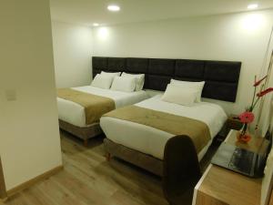 Postel nebo postele na pokoji v ubytování HOTEL MX BOGOTA + 70 fotografií