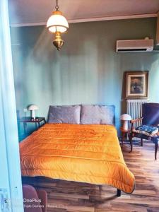 1 dormitorio con 1 cama con manta naranja en Central Sophisticated Studio Pyrgos near Olympia en Pýrgos