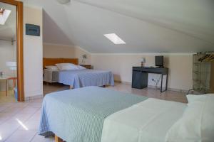 Postel nebo postele na pokoji v ubytování Hotel l'Etrusco - San Vincenzo