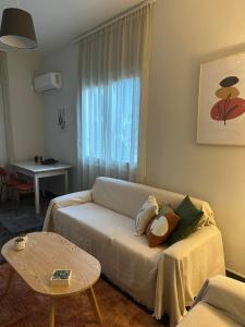 a living room with a couch and a table at Happy Home in Leonidio