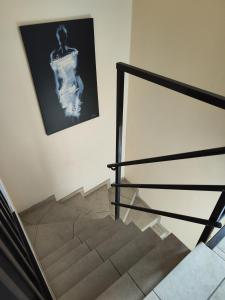 a staircase with a picture of a woman on the wall at loft appartement met 3 slaapkamers en gratis parking in Ichtegem