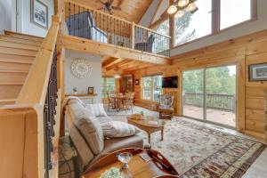 a log home living room with a spiral staircase at Cozy North Carolina Cabin - Deck, Grill and Fire Pit in Bostic