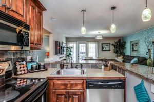 a kitchen with a sink and a stove at Amazing Locale 2KingBR 1BTH in Kansas City