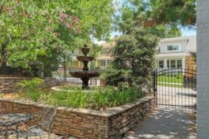 a fountain in a garden in front of a house at Amazing Locale 2KingBR 1BTH in Kansas City