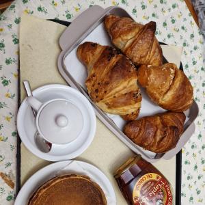 a table with a tray of pastries and a cup of coffee at Otium Relais in Furore