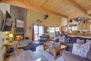 a living room with a couch and a fireplace at Dancing Bear Lodge about 1 Mi to Big Bear Lake! in Big Bear Lake