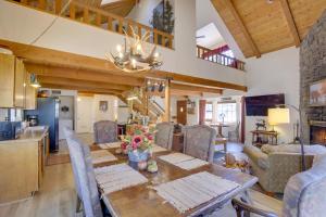 a kitchen and living room with a table and chairs at Dancing Bear Lodge about 1 Mi to Big Bear Lake! in Big Bear Lake