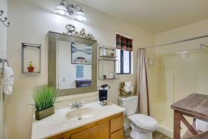 a bathroom with a sink and a toilet and a mirror at Dancing Bear Lodge about 1 Mi to Big Bear Lake! in Big Bear Lake