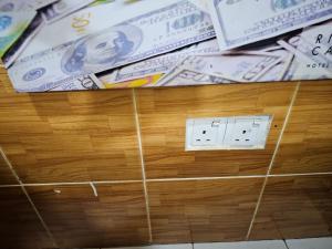 a pile of dollar bills on a wooden wall at 24Seven Guesthouse in Kuala Lumpur