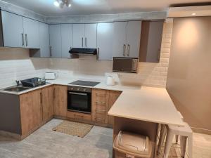 a kitchen with white cabinets and a counter top at 1204 Ten South Beach Apartment in Durban