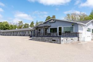 a row of barracks with a building at Aurora Inn in Kingston