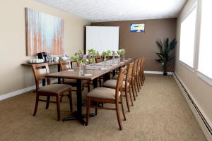 una sala de conferencias con una mesa larga y sillas en Aurora Inn, en Kingston