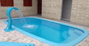 niebieski basen z fontanną wodną w obiekcie Chalé Encanto do Mar 1 w mieście Luis Correia