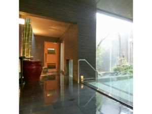 a house with a swimming pool and a large window at Kansai Airport Spa Hotel Garden Palace - Vacation STAY 72631v in Izumi-Sano