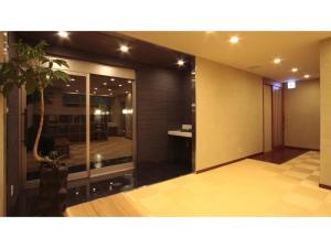 a lobby with a glass door with a plant in it at Kansai Airport Spa Hotel Garden Palace - Vacation STAY 72631v in Izumi-Sano