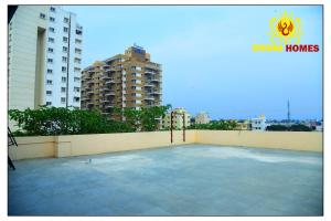 a large patio with buildings in the background at Dhoni Homes -Premium 1 BHK Service Apartment Manyata Tech Park in Bengaluru