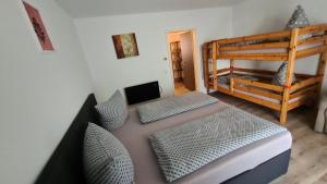 a bedroom with a bed and a bunk bed at Apartment mit 2 Zimmer im Bayerischen Wald in Sankt Englmar +17 photos
