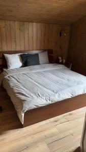 a bedroom with a large bed in a wooden room at Chalet luxueux in Châtel