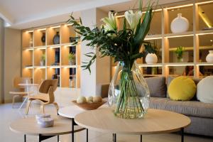 a vase of flowers on a table in a living room at M Concept Hotel in Buenos Aires