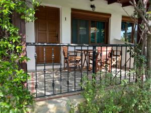 a balcony with a table and chairs on a house at Maniatis Garden in Achladies