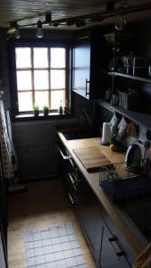 a kitchen with a counter top and a window at Bregnehytte in Leikanger