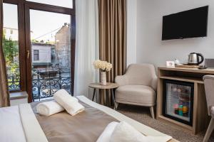 a hotel room with a bed and a fireplace and a balcony at Evelin Deluxe House in Plovdiv