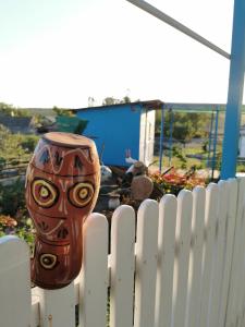 a vase sitting on top of a white fence at La Mădălina in Selemet