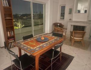 uma sala de jantar com uma mesa e cadeiras e uma lareira em Athens The View em Atenas