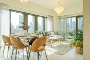 a living room with a table and a couch at FIRST CLASS 2BR with full BURJ KHALIFA view in Dubai
