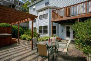 a patio with a table and chairs in front of a house at Luxury Bachelor by Halifax Waterfront -Hot Tub in Halifax