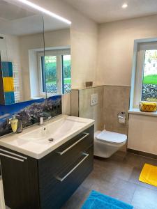 a bathroom with a sink and a toilet at MOUNTAIN HOME apartment in Finkenberg