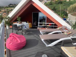 une terrasse avec des chaises, une table et une tente dans l'établissement Studio privado com vista mar e montanha, à Ponta do Sol