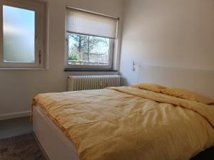 a bedroom with a bed and a window at Le Chateau Blanc in Verviers