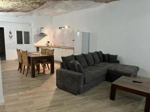 a living room with a couch and a table at Cueva Lala in Granadilla de Abona