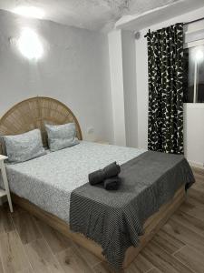 a bedroom with a large bed with a wooden headboard at Cueva Lala in Granadilla de Abona