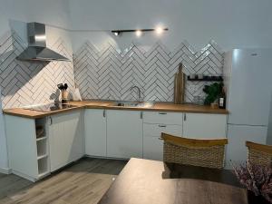 a kitchen with a sink and a refrigerator at Cueva Lala in Granadilla de Abona +13 photos