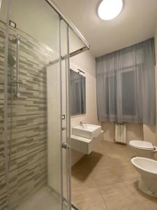 a bathroom with a shower and a sink and a toilet at Home & B in Arezzo +28 photos