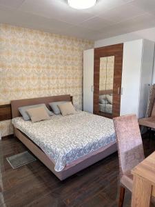 een slaapkamer met een groot bed en een tafel bij Apartman Stefan in Pančevo