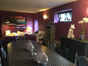 a living room with a dining table and a living room at Domaine de Godchure - Gîte & Spa 