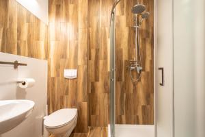 a bathroom with a shower with a toilet and a sink at Hotel i Restauracja Stara Kuźnia in Dobczyce