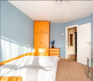 a bedroom with a bed and a dresser in it at Apartment with a panoramic view of Podil near the metro in Kyiv