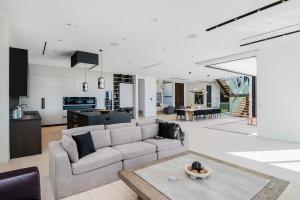 a living room and kitchen with a couch and a table at Linda Flora Modern Estate in Los Angeles